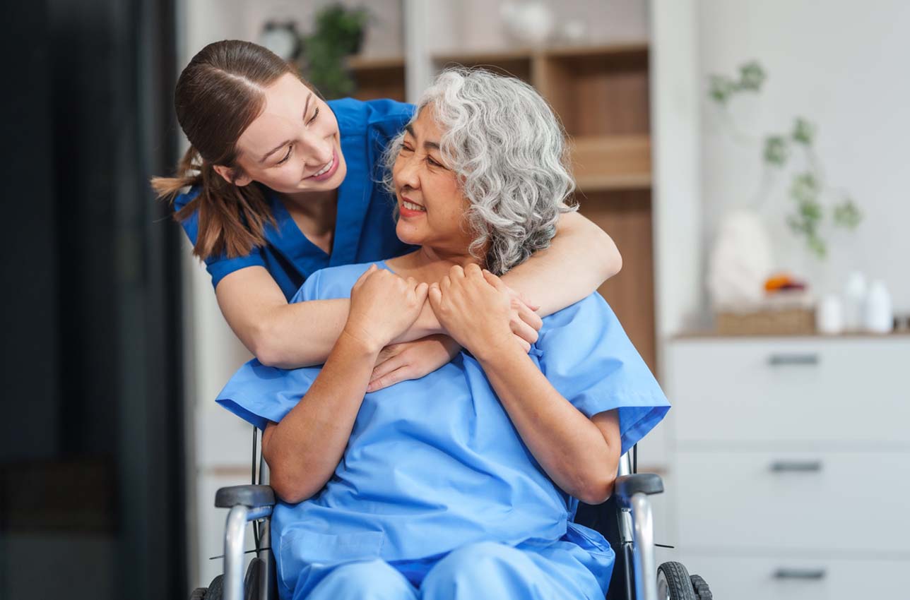 Caregiver helping adult woman in home