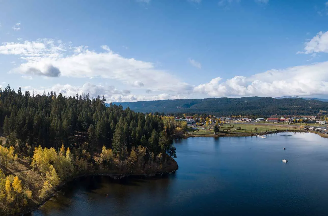 areas-served-liberty-lake-washington Scenic lake framed by trees under a blue sky