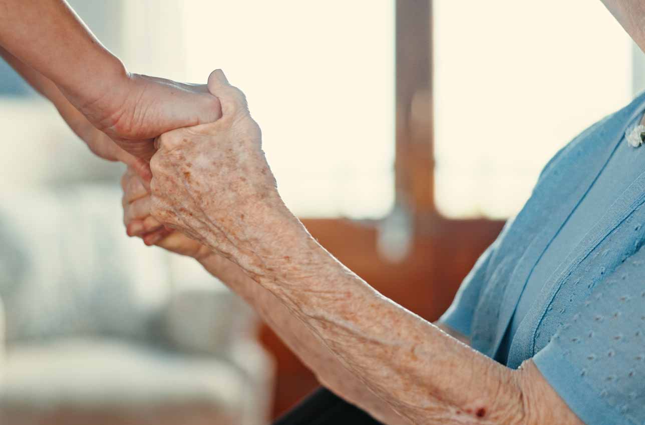 Senior woman holding hands and support in elder care